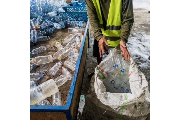 Image Collecting empty plastic bottles.